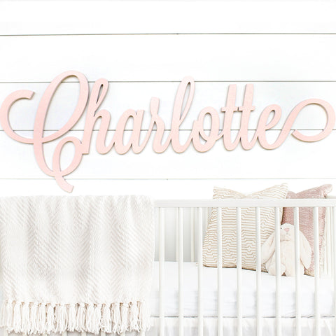 Blush Pink Nursery Name Sign on Shiplap Wall Over Crib